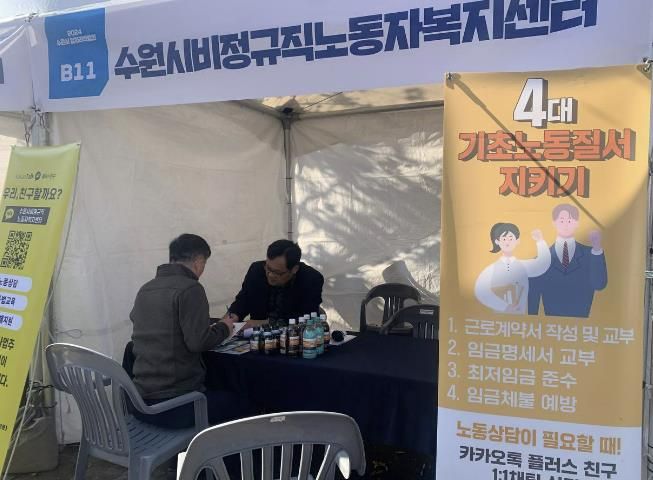 캠페인 부스에서 시민과 노동상담을 하고 있다.